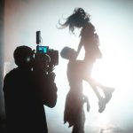 a person holding a camera in the air